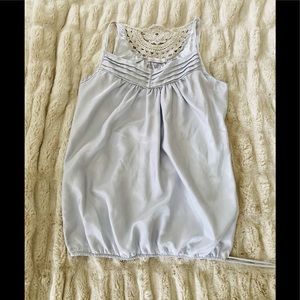 Sleeveless baby blue silky top with tie bottom